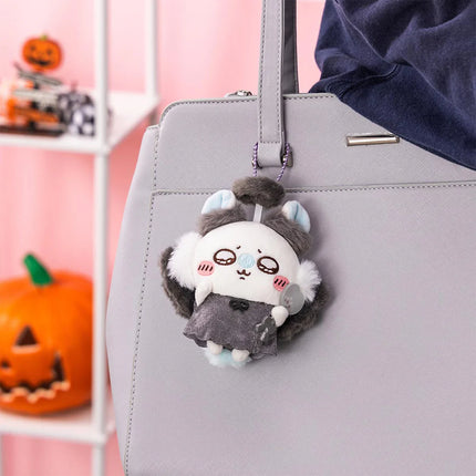 Seasonal plush keychain with gray ears and a small white face, hanging from a gray bag